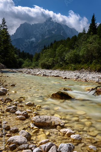 River, forest and mountains near Kranjska Gora town in Triglav national park, Slovenia - long exposure