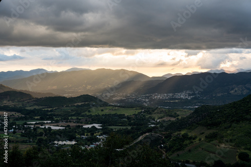 Dramatic image of a approaching rainstorm high in the Caribbean mountains of the Dominican Republic with a small town in the valley.