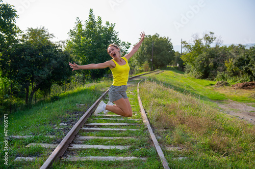funny girl jumping on the railroad tracks © Vyacheslav