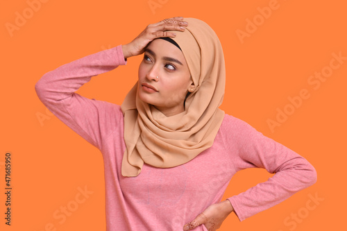 young muslim girl wearing hijab posing over orange background indan pakistani model photo