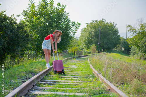 a girl dragging a very heavy suitcase on the sleepers