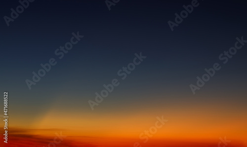 Heaven at early morning with copy space. Sunset, sunrise backdrop.Predawn clear sky with orange horizon and blue atmosphere. Smooth orange blue gradient of dawn sky. © AungMyo
