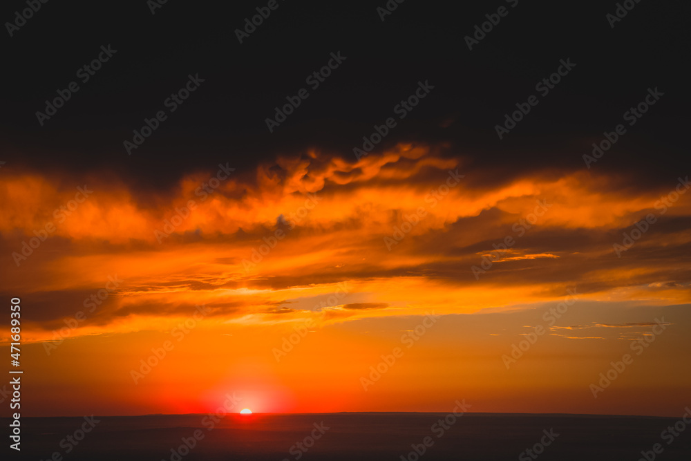 Panoramic shot of a landscape, orange sunset in the water of the sea, ocean with lush clouds, clouds to replace the background wall and model
