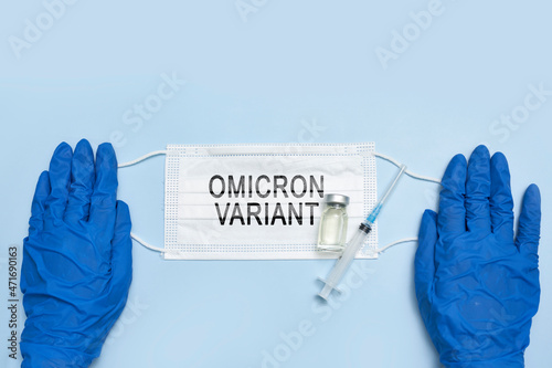 Female doctor holds a face mask with - Omicron variant text on it. Covid-19 new variant - Omicron. Omicron variant of coronavirus. SARS-CoV-2 variant of concern photo