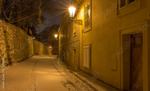 Prague - winter evening in a snowy historic street in Hradcany