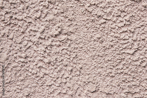 Old pink wall with peeling plaster, grunge background