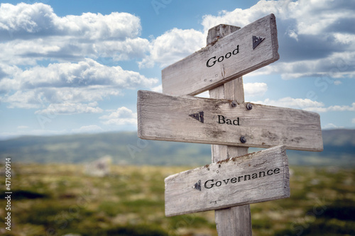 good bad governance text quote on wooden signpost outdoors in nature. Blue sky above. photo