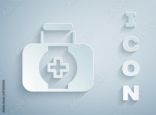 Paper cut First aid kit icon isolated on grey background. Medical box with cross. Medical equipment for emergency. Healthcare concept. Paper art style. Vector