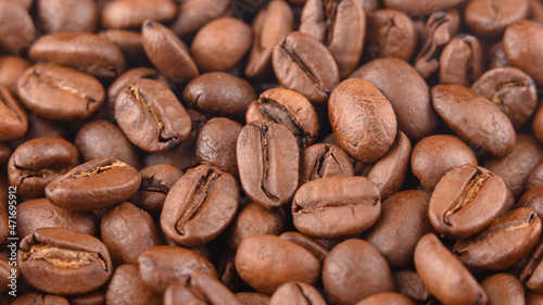 Coffee grains background macro under hard light. Photo horizontal HD