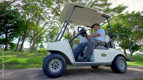 Group of Asian people businessman and senior CEO enjoy outdoor activity lifestyle sport golfing together at golf country club. Healthy men golfer driving golf cart on golf course in summer sunny day photo