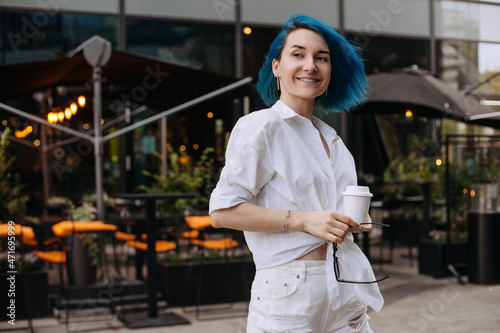 Portrait of beautiful casual women walking outside her office. © Sotnikow