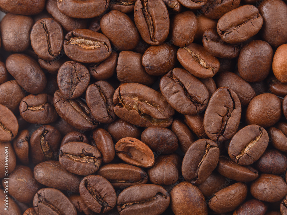 Fototapeta premium Coffee texture beans macro under hard light. Photo horizontal HD