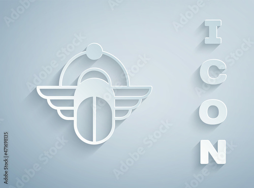 Paper cut Egyptian Scarab icon isolated on grey background. Winged scarab Beetle and sun. Paper art style. Vector