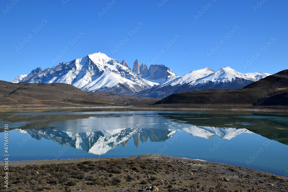 Torres del Paine in a beautiful sunny day showing contrast with the blue sky and white snowy mountain, Argentina Chile