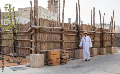 Canvas Print Arab man walking in the alleys of al seef district in Dubai