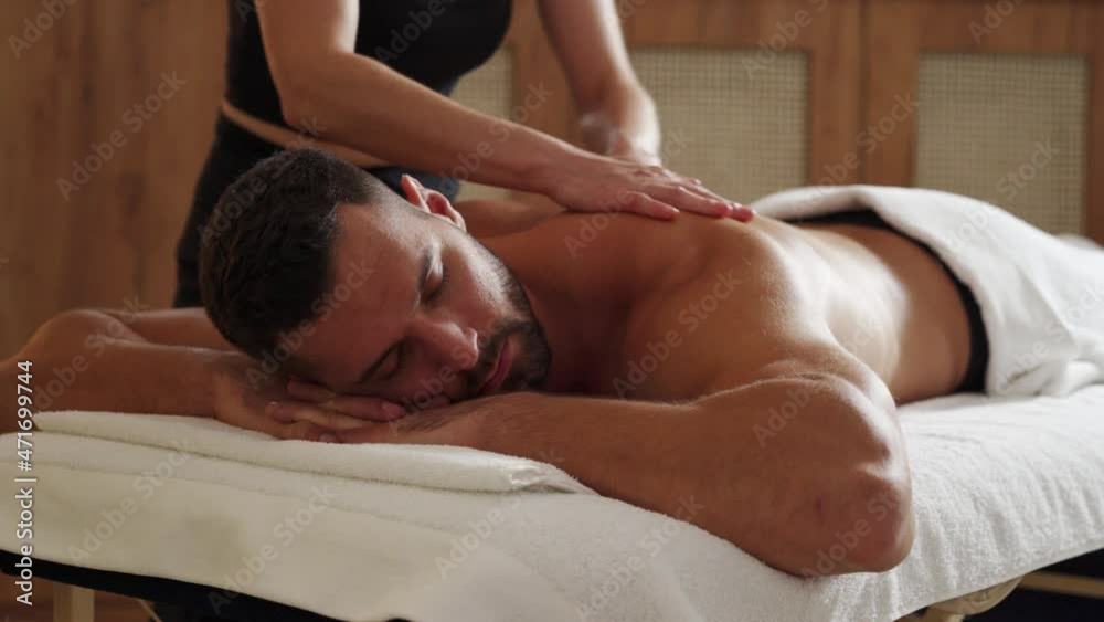 Young man having a massage by a professional masseuse