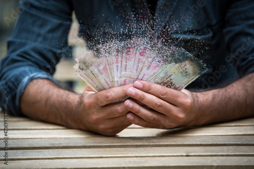 Fototapeta Naklejka Na Ścianę i Meble -  hand holding money. Financial crisis concept