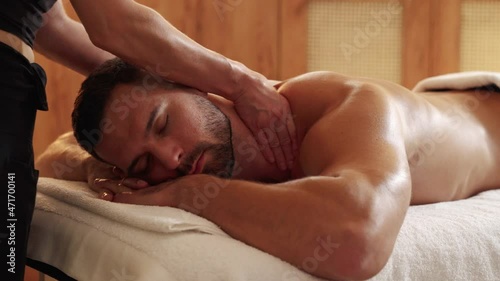 Close-up on a man receiving thai massage