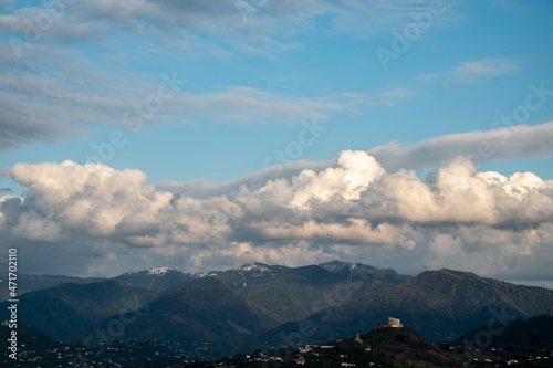 Huge  white clouds over the mountains. Panorama of mountains  hills of the city of Batumi from a bird s eye view. Day. Georgia. Sunny
