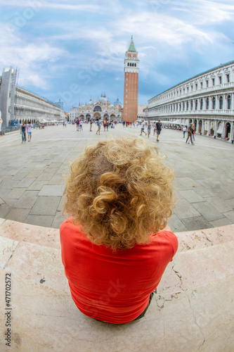 attractive woman in Venice sitting at st. Mark's square and enjoying the scene photo