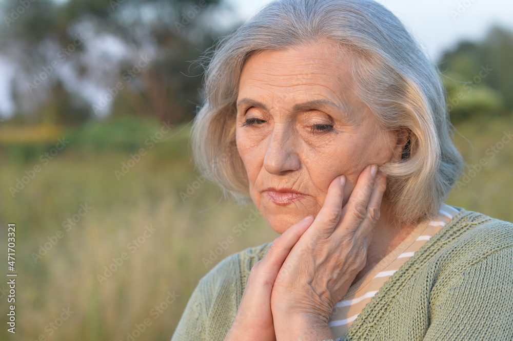 sad senior beautiful woman in park sad senior beautiful woman in park