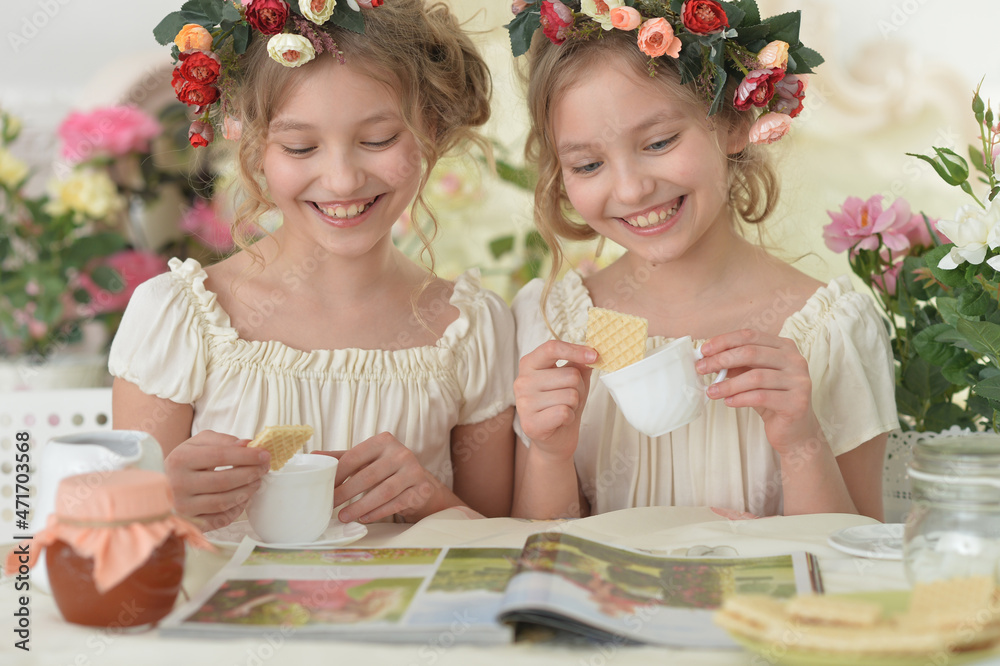 girls reading magazine, and drinking tea