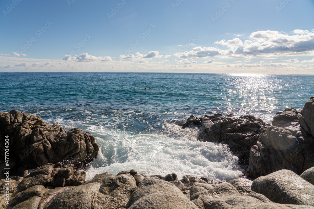 waves splashes on rock in sea shore, pretty calm sea with blue sky and some clouds