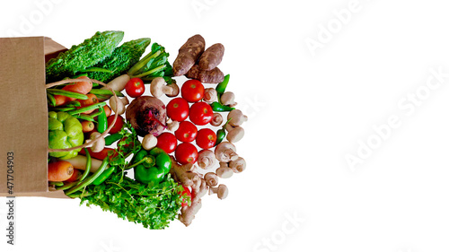 Fresh vegetable grocery bag. vegetable groceries paper bag supermarket cart. Top view copy space white background.
