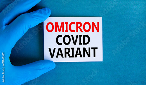 New covid-19 omicron variant strain symbol. Hand in blue glove with white card. Concept words Omicron covid variant. Medical and COVID-19 omicron variant strain concept. Copy space.