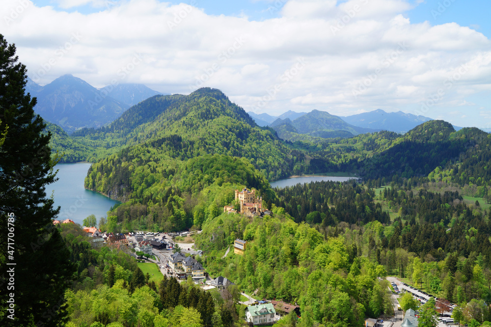 medieval Hohenschwangau Castle (Schloss Hohenschwangau) in the Alps and lakes Alpsee and Schwansee in the background photographed from the bridge Marienbruecke (Bavaria, Germany)