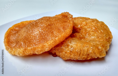 Two pieces of bowsprit cake or kue cucur. Indonesian traditional cake, made from flour and brown sugar. photo