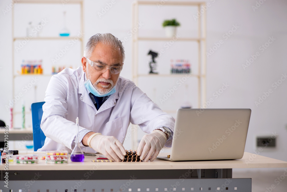 Old male chemist in drug synthesis concept Old male chemist in drug synthesis concept