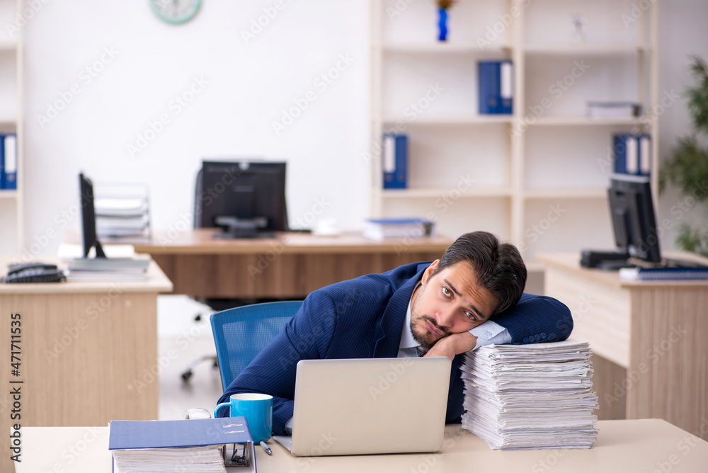 Young male employee working in the office Young male employee working in the office