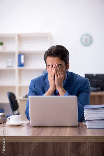 Young male employee working in the office