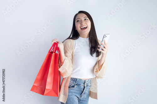 Woman Carrying Red Shopping Bag, and Mobilephone with Happy Face
