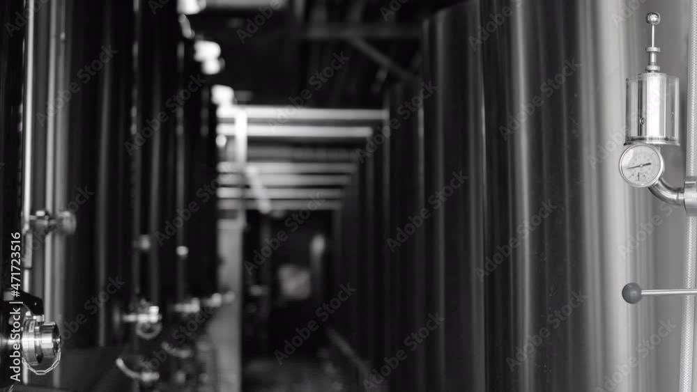 Private microbrewery. Modern beer plant with brewering kettles, tubes and tanks made of stainless steel Private microbrewery. Modern beer plant with brewering kettles, tubes and tanks made of stainless steel