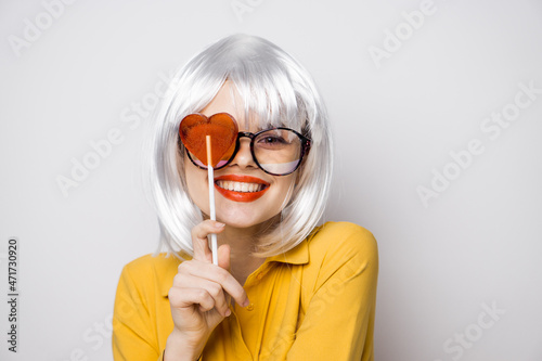 cheerful glamorous woman with a lollipop in her hands model