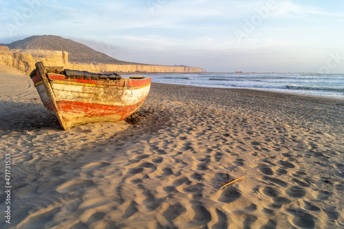 Wreckage of an old boat on the beach by the sea