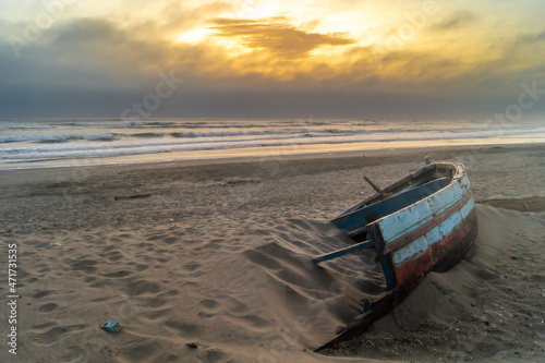 Wreckage of an old boat on the beach by the sea