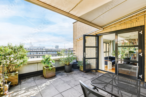 Schilderij op canvas Lovely balcony with lots of potted flowers and amazing views