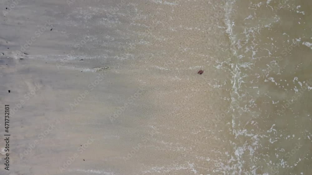 Top down view gentle wave hit at sea shore Top down view gentle wave hit at sea shore