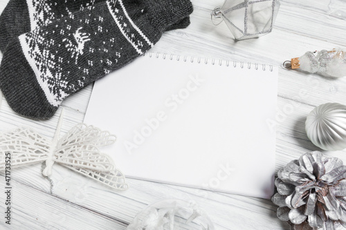 silver christmas decorations and notebook on white background. Flat lay, top view, copy space- Image