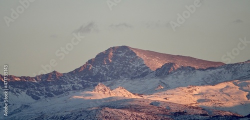 View of the snowy Mulhacen in Sierra Nevada (Spain) at sunset; It is the highest mountain in the Iberian Peninsula