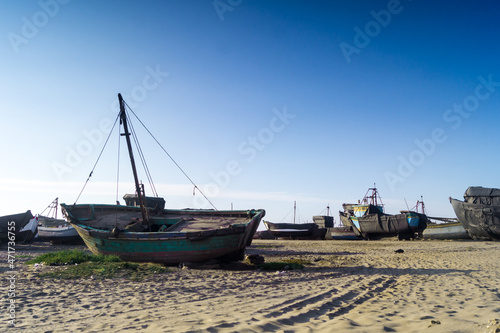 Wreckage of an old boat on the beach by the sea