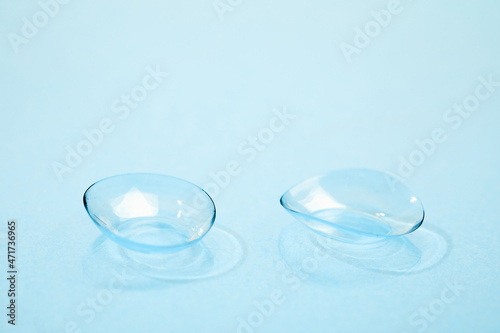 contact lenses on blue background close up view   - Image