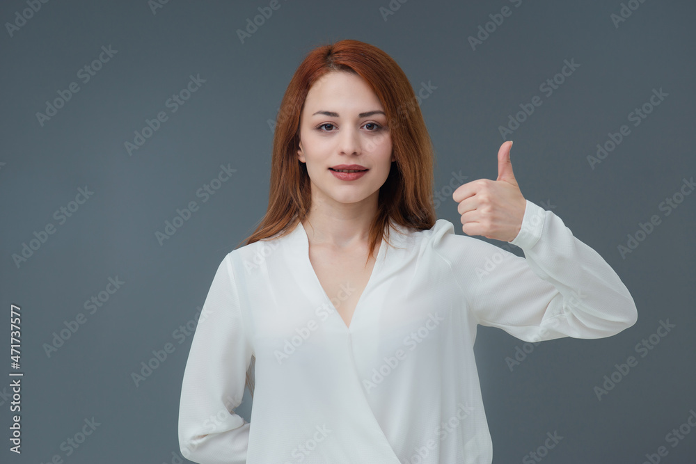 Beautiful smiling Turkish young woman, gestures thumbs up, Includes copy space. Beautiful smiling Turkish young woman, gestures thumbs up, Includes copy space.