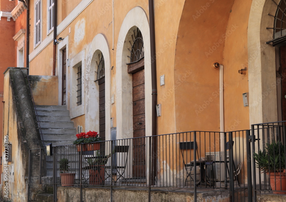 Trastevere Traditional House Facades with Arched Entrances, Entrance Steps and Potted Red Cyclamen in Rome, Italy