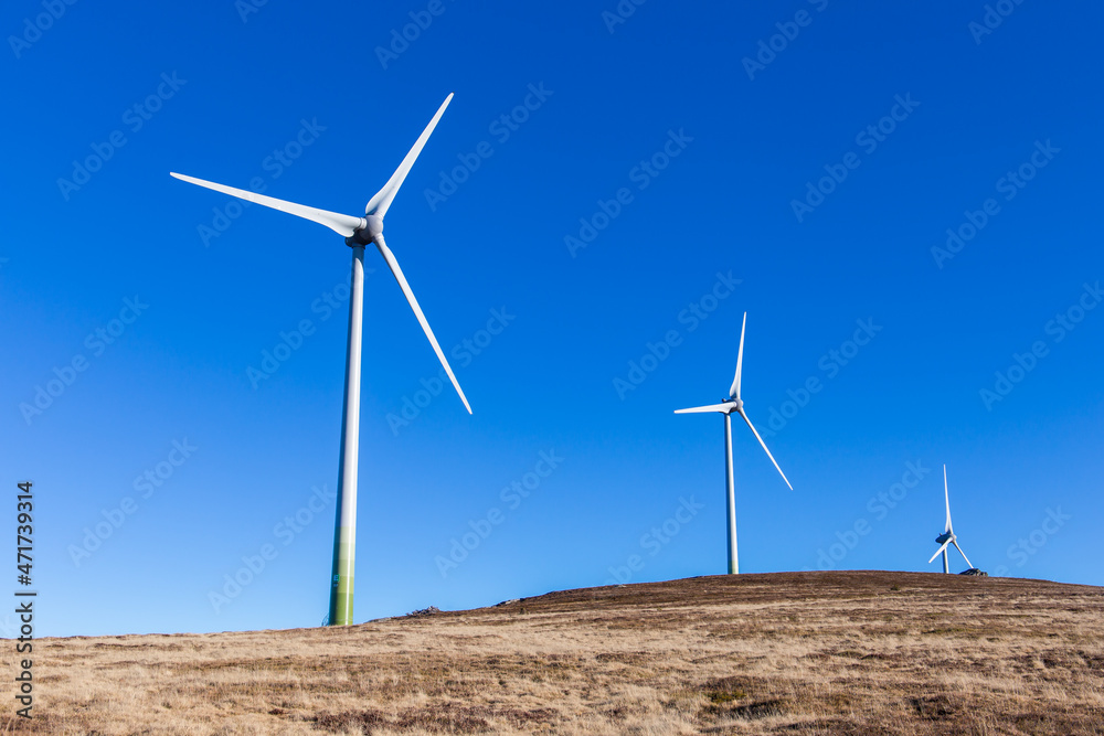 Windpark at the Handalm mountain range in Styria, Austria in autumn with blue clear skies Windpark at the Handalm mountain range in Styria, Austria in autumn with blue clear skies