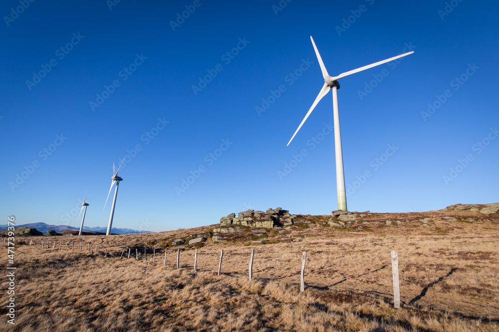 Windpark at the Handalm mountain range in Styria, Austria in autumn with blue clear skies