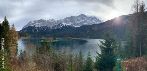 Eibsee in Autumn November with sunshine, trees and the Zugspitze mountain in the background, Bavaria Allgäu Germany